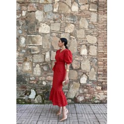 Mujer luciendo look con vestido midi rojo elegante en posicion lateral